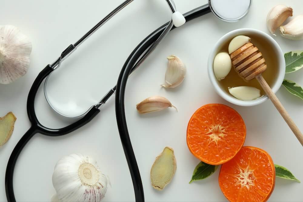A stethoscope, oranges, garlic and garlic.